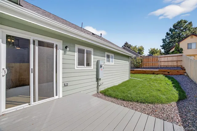 a view of backyard of house with green space
