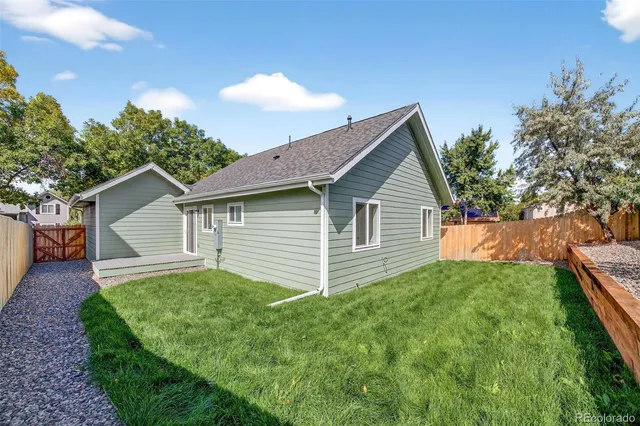a view of a backyard with wooden fence