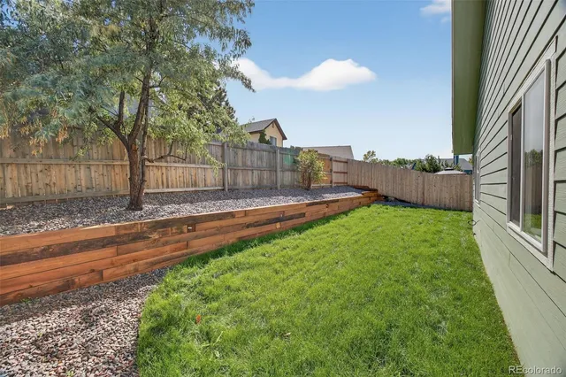 a front view of house with yard and trees