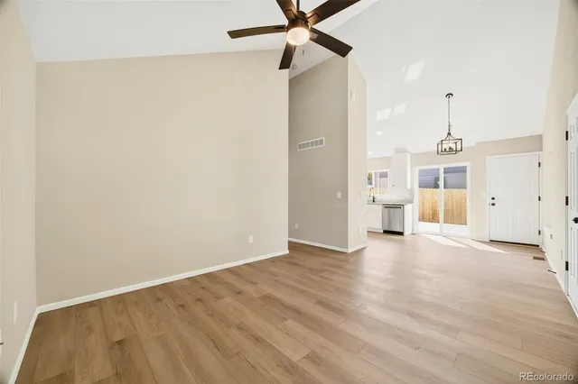 wooden floor in an empty room with a ceiling fan