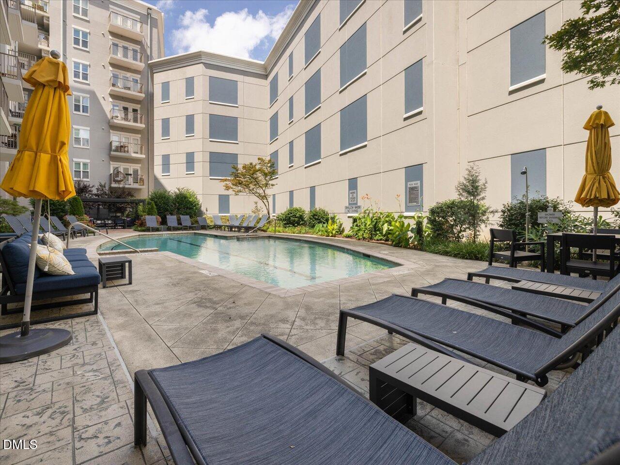 222 Glenwood Avenue, Unit 304 Raleigh, NC 27603 - Photo 11 of 23 a view of a patio with chairs and table on the wooden floor