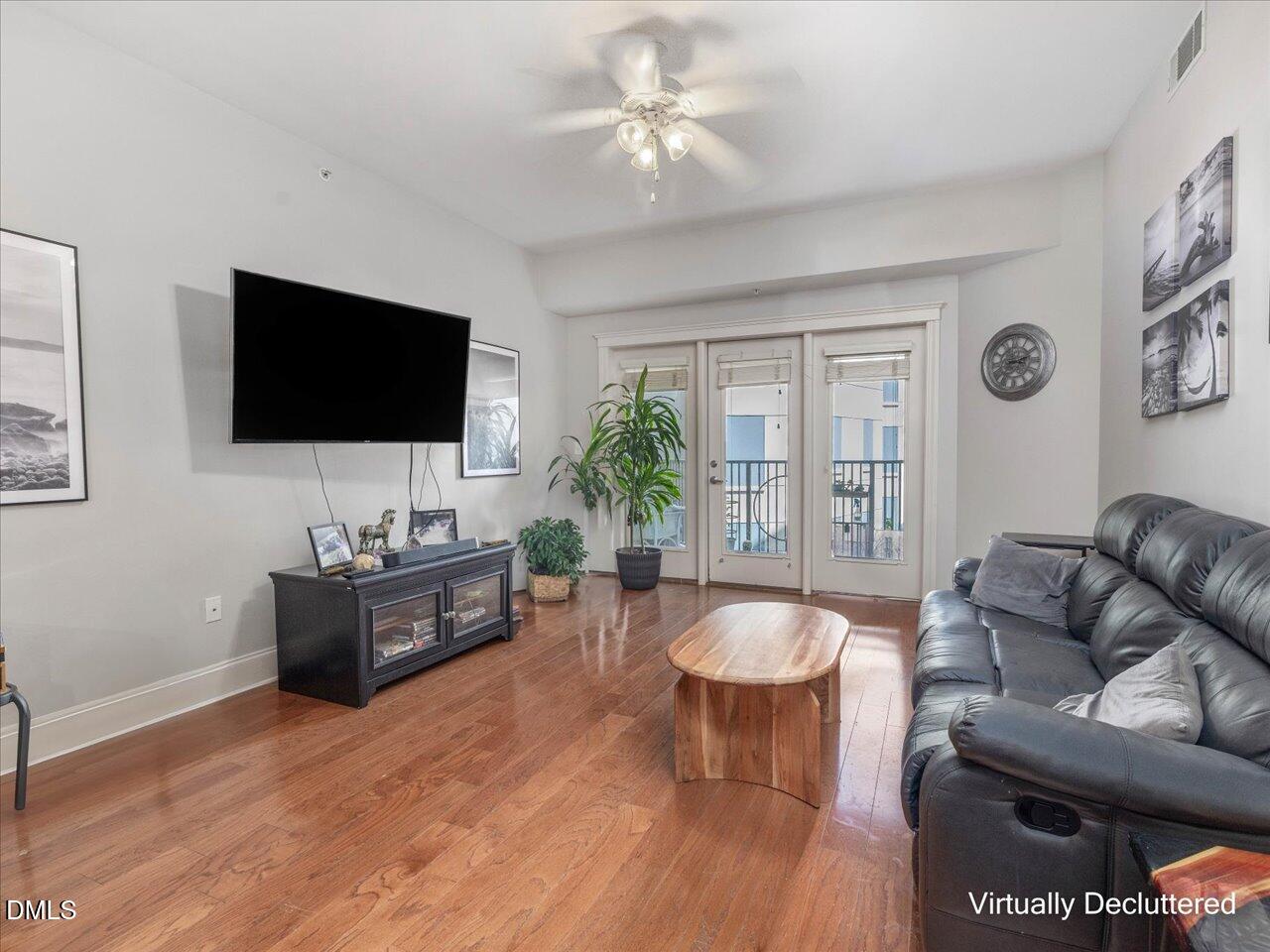 222 Glenwood Avenue, Unit 304 Raleigh, NC 27603 - Photo 12 of 23 a living room with furniture and a flat screen tv