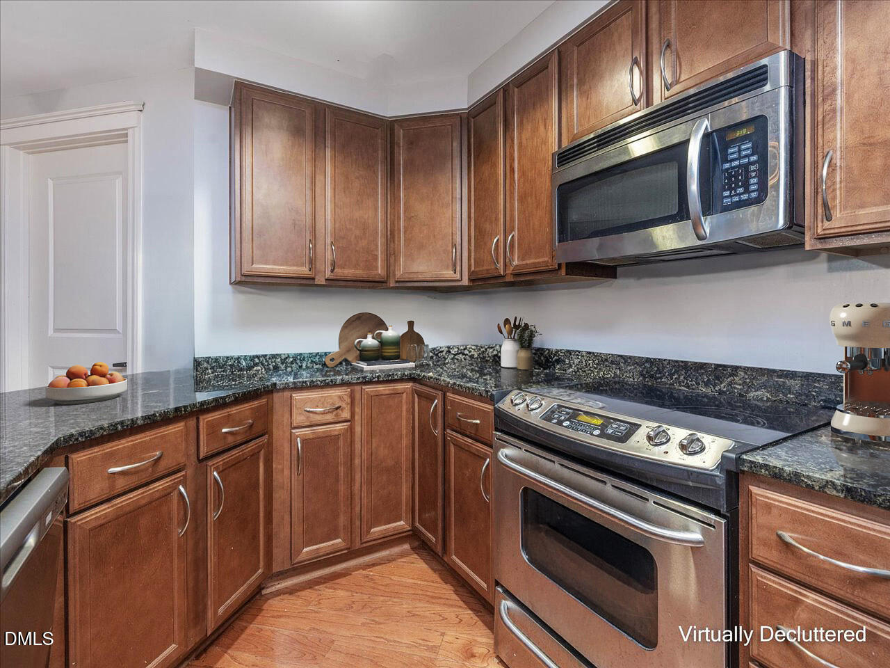222 Glenwood Avenue, Unit 304 Raleigh, NC 27603 - Photo 14 of 23 a kitchen with stainless steel appliances granite countertop a stove microwave and cabinets