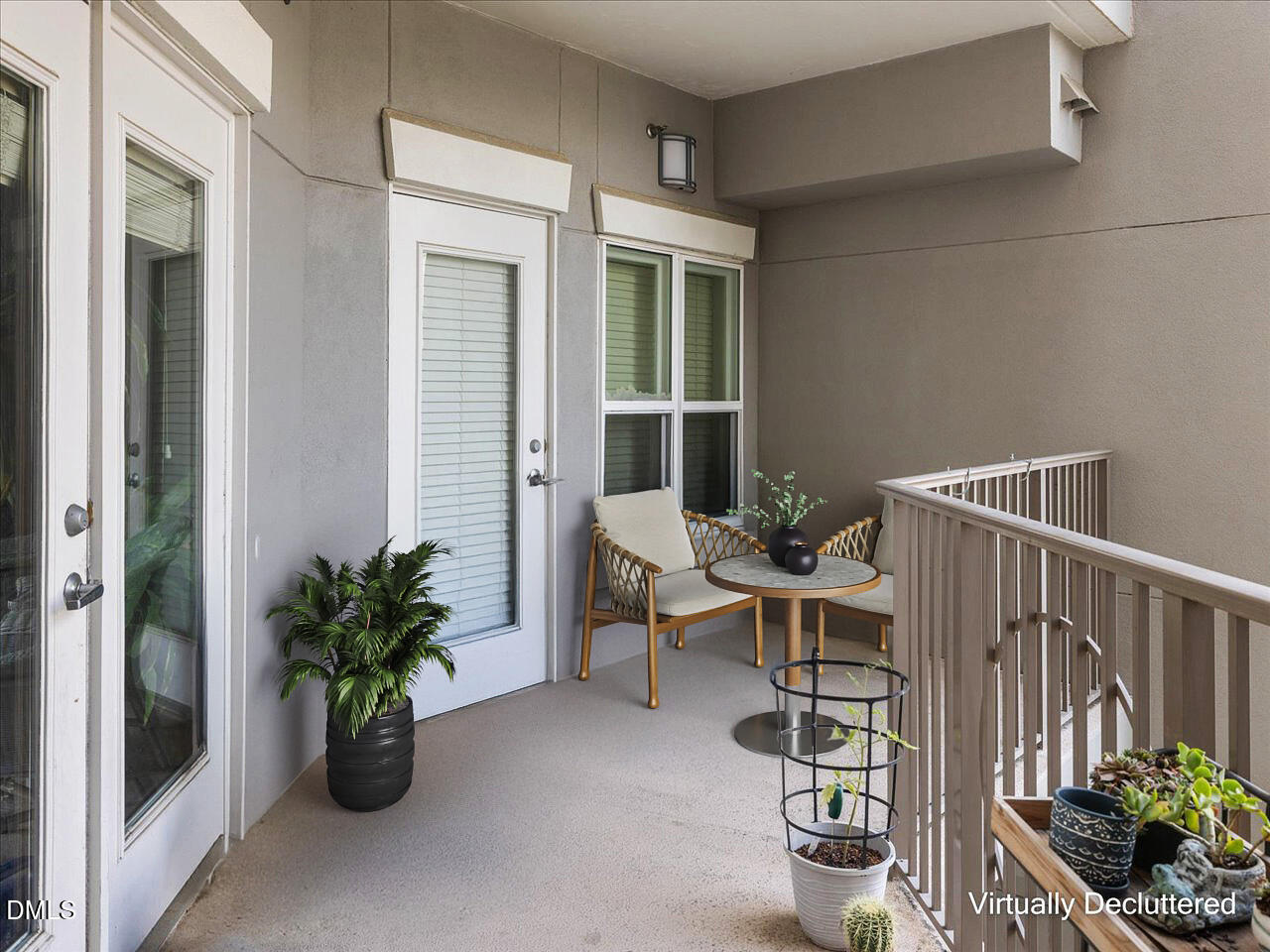 222 Glenwood Avenue, Unit 304 Raleigh, NC 27603 - Photo 19 of 23 a view of a deck with table and chairs potted plants