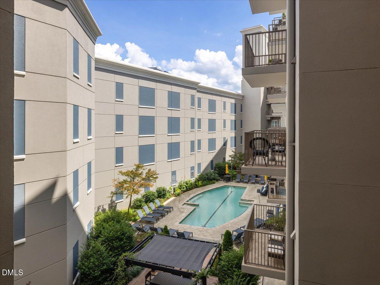 222 Glenwood Avenue, Unit 304 Raleigh, NC 27603 - Photo 20 of 23 a view of a building with a yard