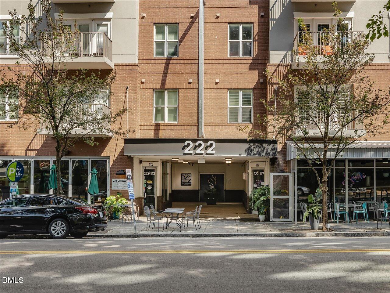 222 Glenwood Avenue, Unit 304 Raleigh, NC 27603 - Photo 21 of 23 a view of a building and a cars park in front of a building