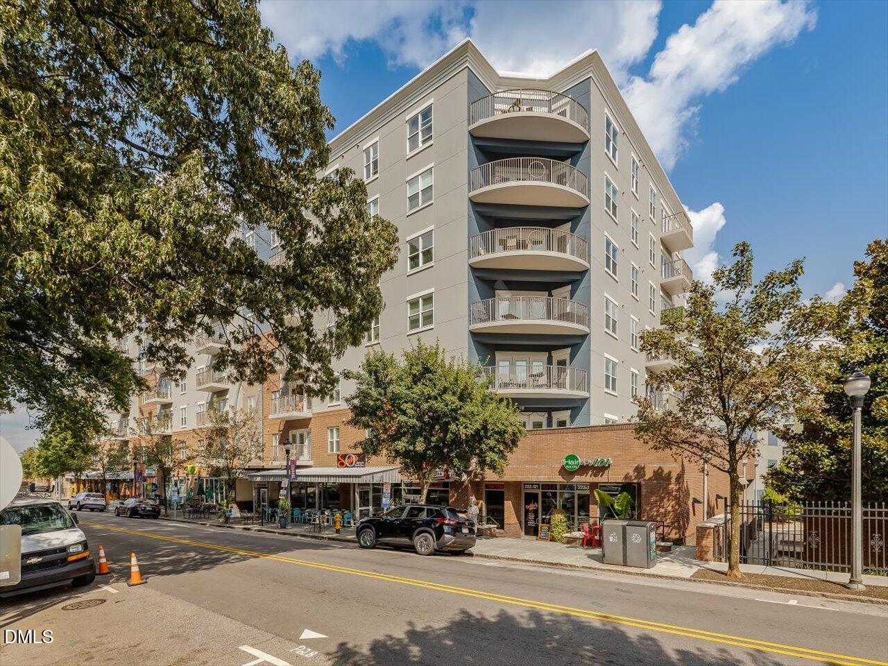 222 Glenwood Avenue, Unit 304 Raleigh, NC 27603 - Photo 23 of 23 a view of a city street lined with buildings and trees