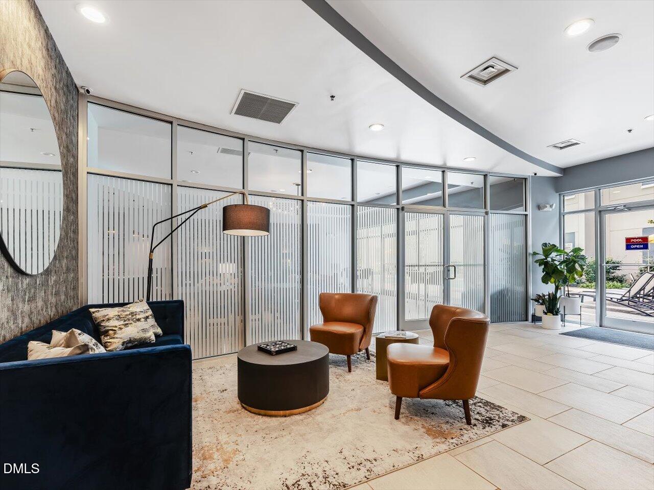 222 Glenwood Avenue, Unit 304 Raleigh, NC 27603 - Photo 3 of 23 a living room with furniture and a floor to ceiling window