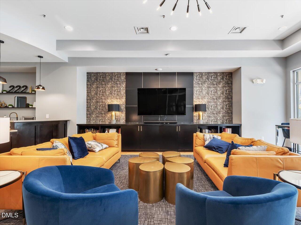 222 Glenwood Avenue, Unit 304 Raleigh, NC 27603 - Photo 5 of 23 a living room with fireplace furniture and a flat screen tv