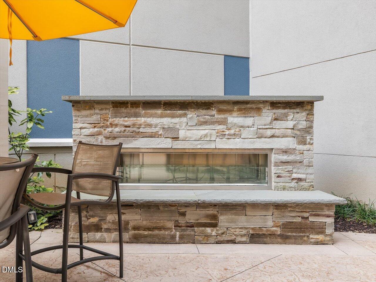 222 Glenwood Avenue, Unit 304 Raleigh, NC 27603 - Photo 8 of 23 a view of a chairs and table in the back yard