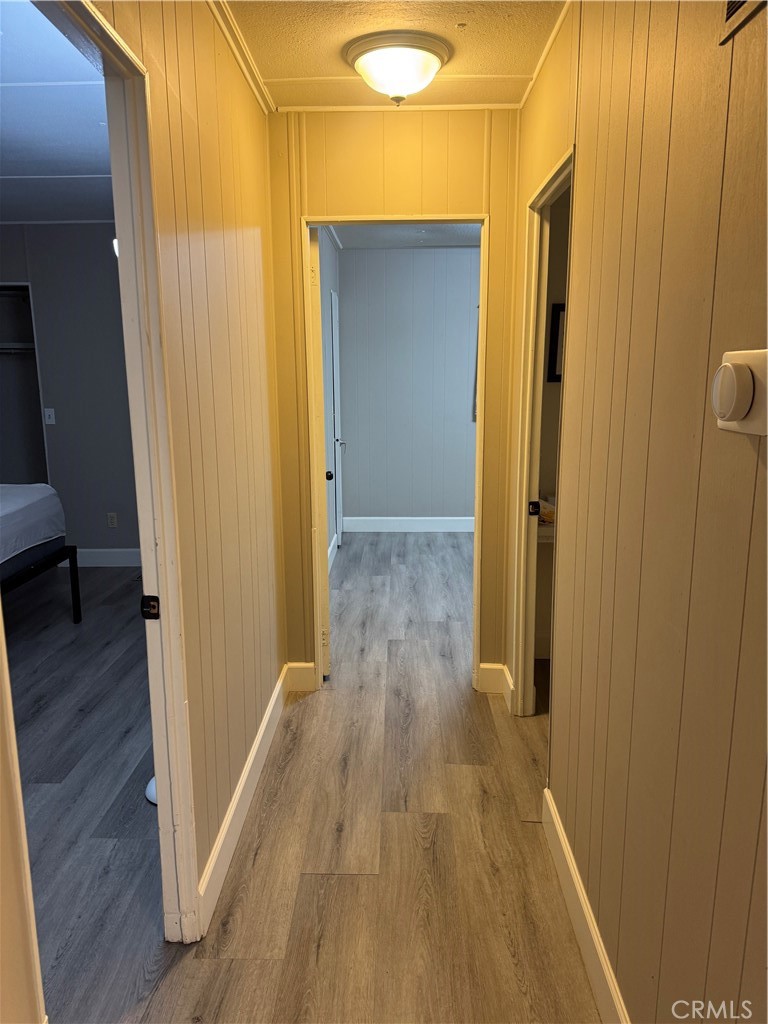 2751 Reche Canyon Road, Unit 185 Moreno Valley, CA 92555 - Photo 11 of 17 a view of a hallway with wooden floor