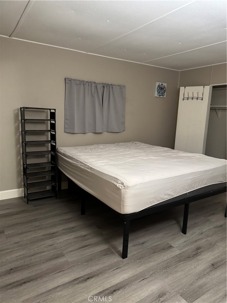 2751 Reche Canyon Road, Unit 185 Moreno Valley, CA 92555 - Photo 12 of 17 a bedroom with a bed and a table