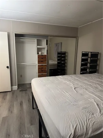 a view of room with wooden floor and cabinet