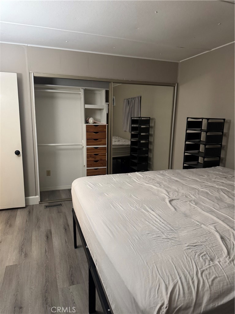 2751 Reche Canyon Road, Unit 185 Moreno Valley, CA 92555 - Photo 13 of 17 a bedroom with a bed and a cabinets