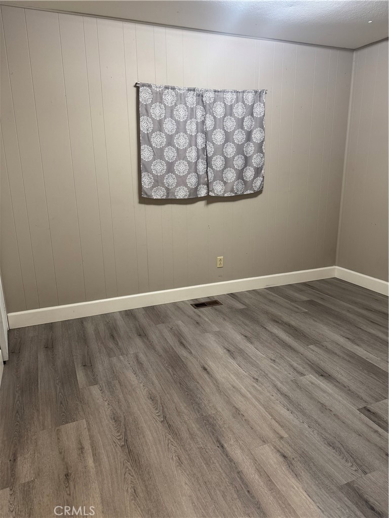 2751 Reche Canyon Road, Unit 185 Moreno Valley, CA 92555 - Photo 14 of 17 a view of room with wooden floor and cabinet