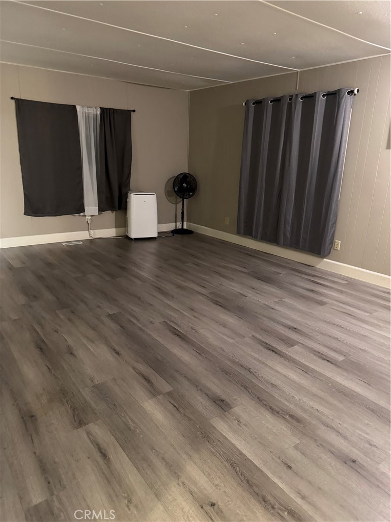 2751 Reche Canyon Road, Unit 185 Moreno Valley, CA 92555 - Photo 4 of 17 a view of an empty room with wooden floor
