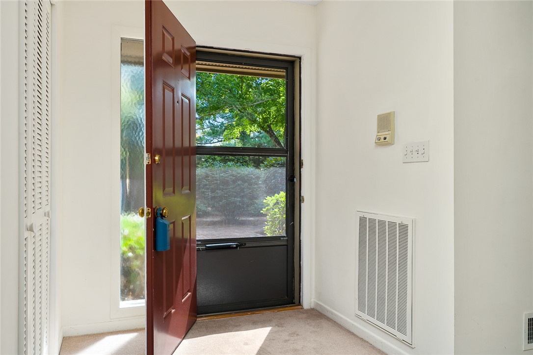34 Hickory Way Clemson, SC 29631 - Photo 7 of 39 A welcoming entry point with a robust front door, inviting verdant outdoor views indoors.