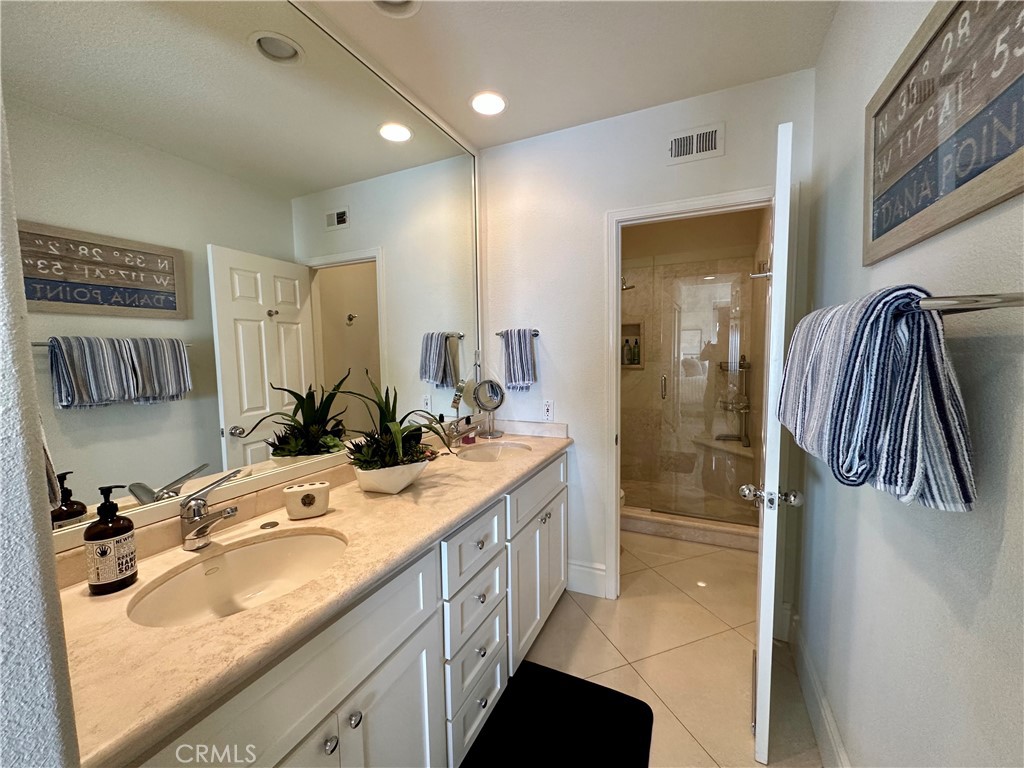 17 Centre Court, Unit 86 Dana Point, CA 92629 - Photo 15 of 21 a bathroom with a sink double vanity and a shower
