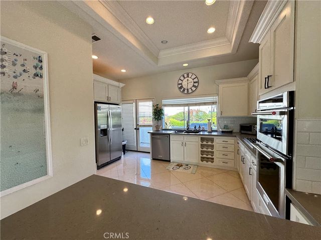 a kitchen with stainless steel appliances a refrigerator and a stove top oven