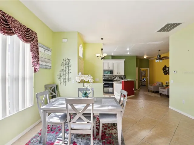 a view of a dining room with furniture and a chandelier
