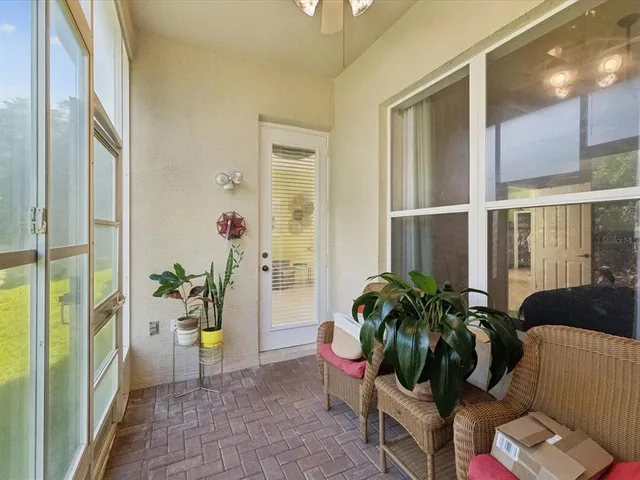a living room with furniture and potted plants