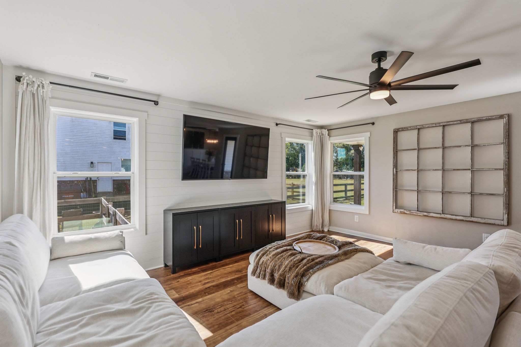 310 Skipping Stone Road Christiana, TN 37037 - Photo 11 of 50 a spacious bedroom with a large bed a flat screen tv and a couch