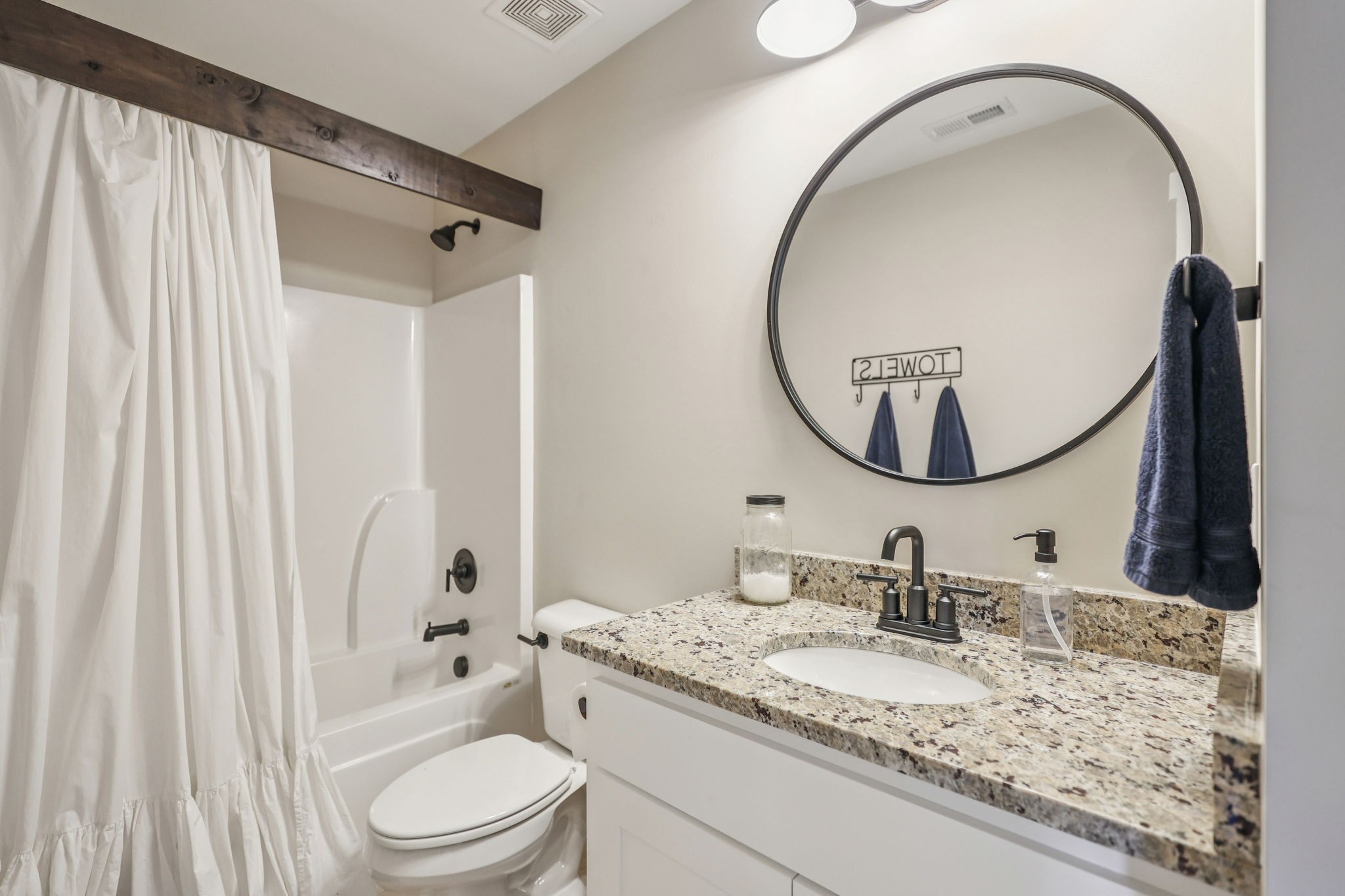 310 Skipping Stone Road Christiana, TN 37037 - Photo 20 of 50 a bathroom with a granite countertop sink mirror vanity and a toilet