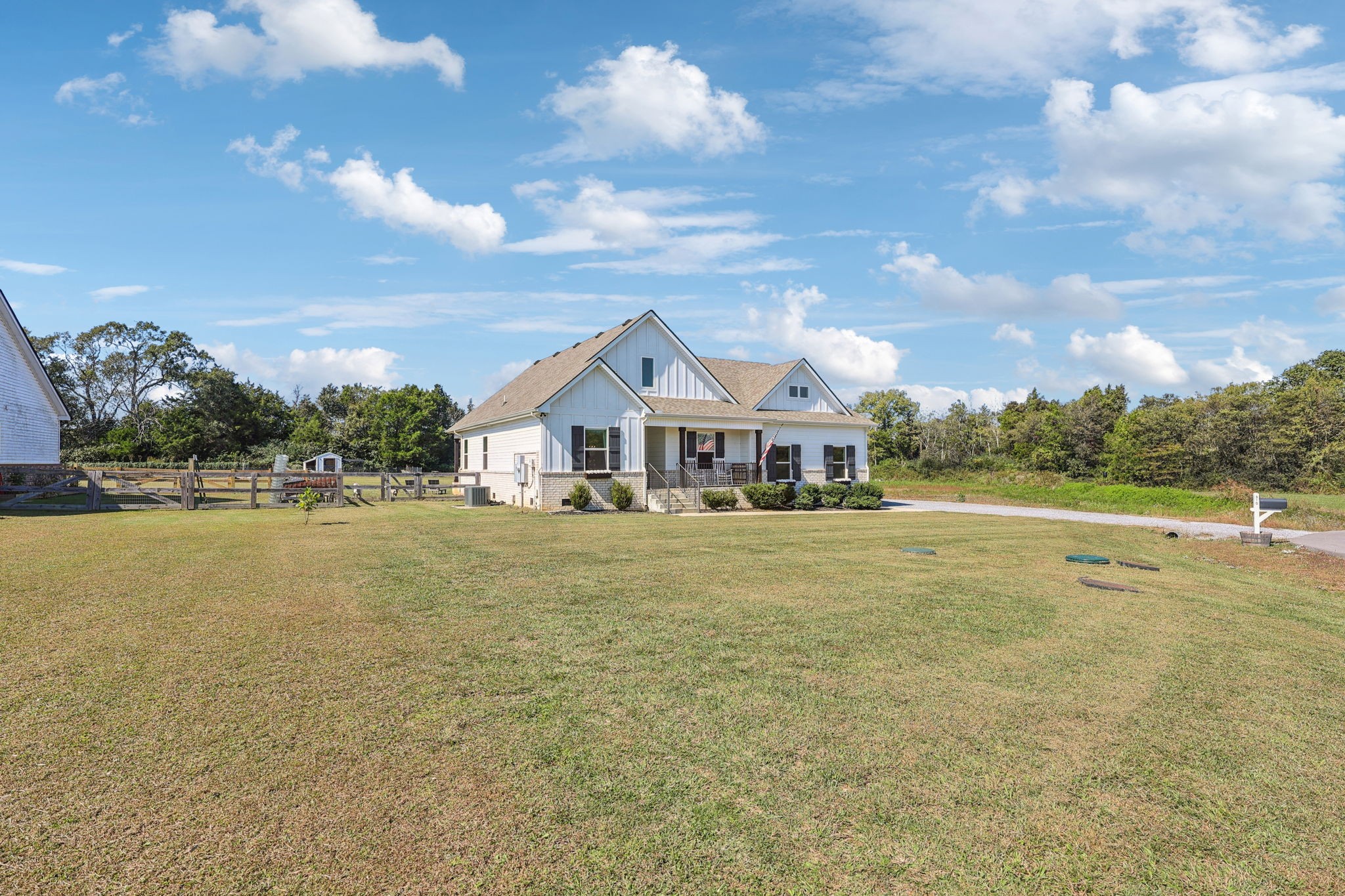 310 Skipping Stone Road Christiana, TN 37037 - Photo 39 of 50 a view of a white house with a large pool and a yard in the back