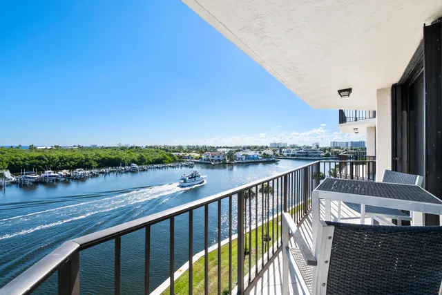 a balcony with wooden floor and outdoor seating