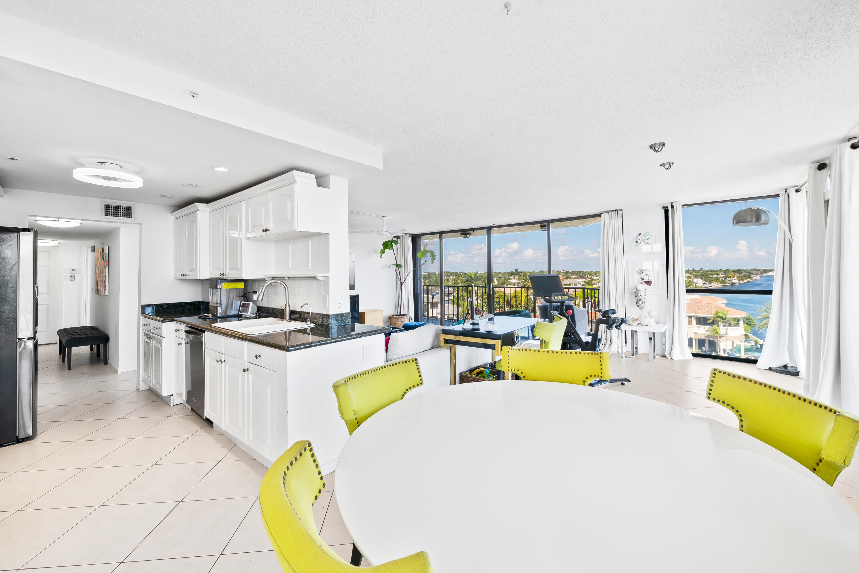899 Jeffery Street, Unit 614 Boca Raton, FL 33487 - Photo 11 of 60 a large white kitchen with a large window and swimming pool