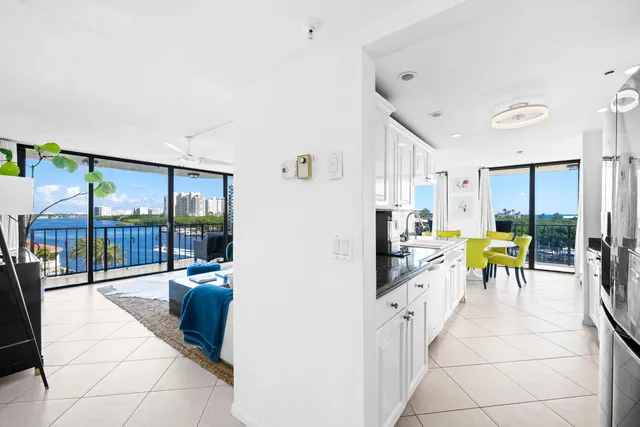 a living room with lots of furniture and kitchen view