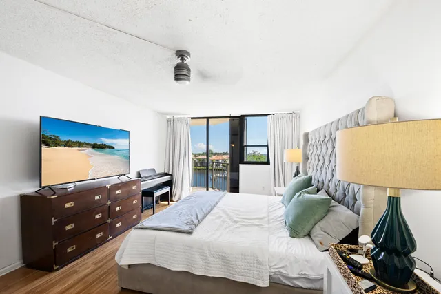 a bedroom with a bed and a large window