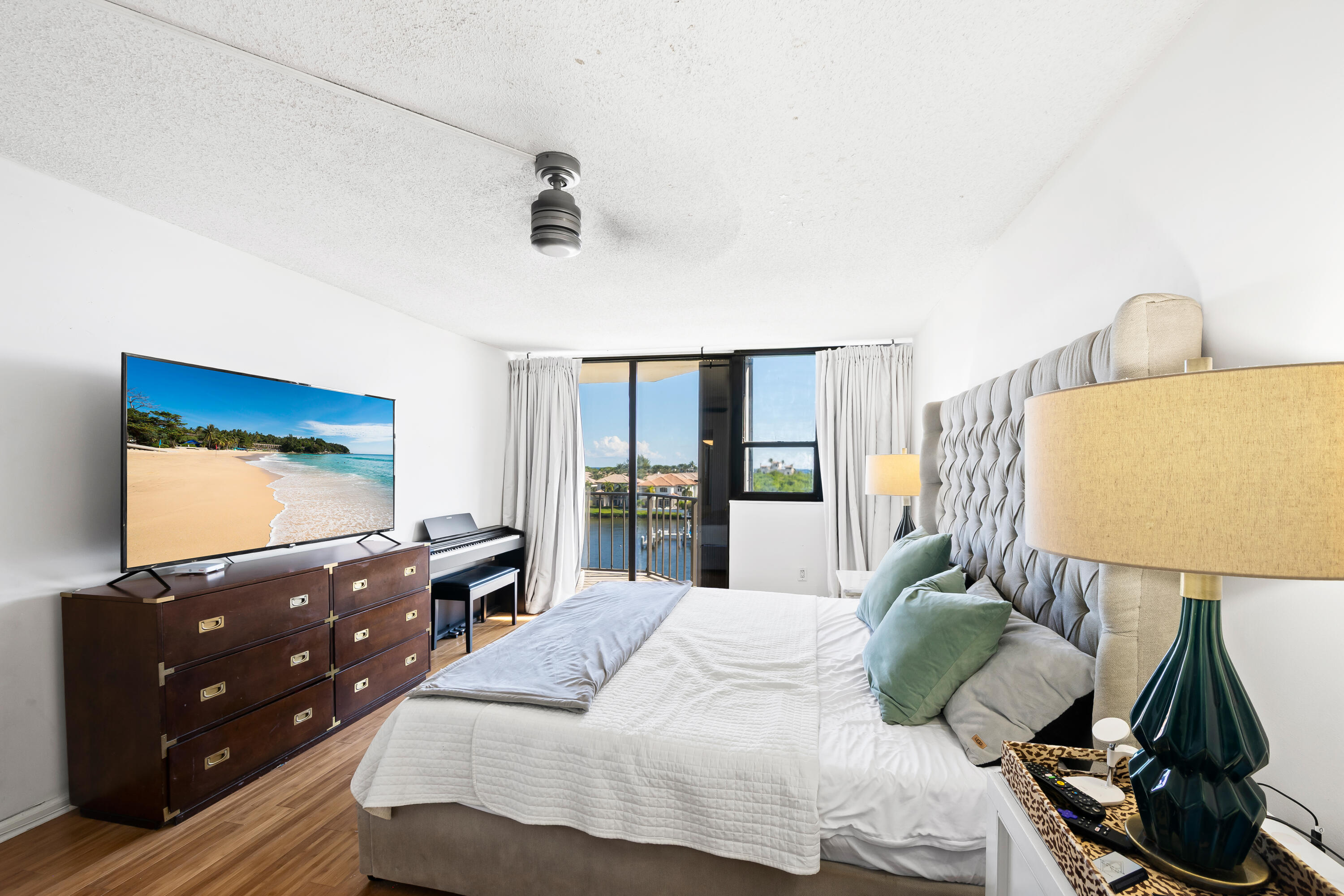 899 Jeffery Street, Unit 614 Boca Raton, FL 33487 - Photo 19 of 60 a bedroom with a bed and a flat tv screen on dresser