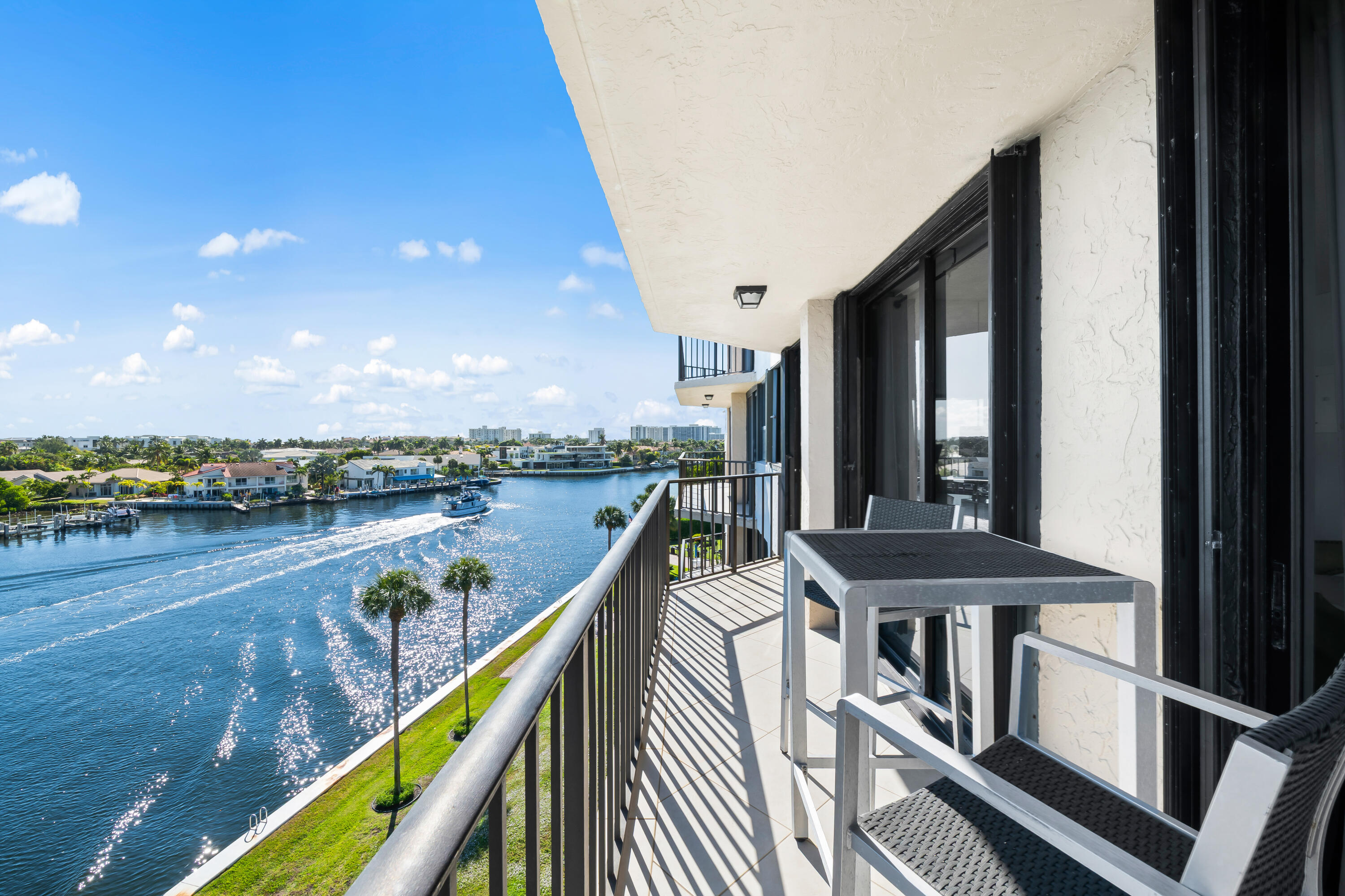 899 Jeffery Street, Unit 614 Boca Raton, FL 33487 - Photo 2 of 60 a balcony with wooden floor and outdoor seating