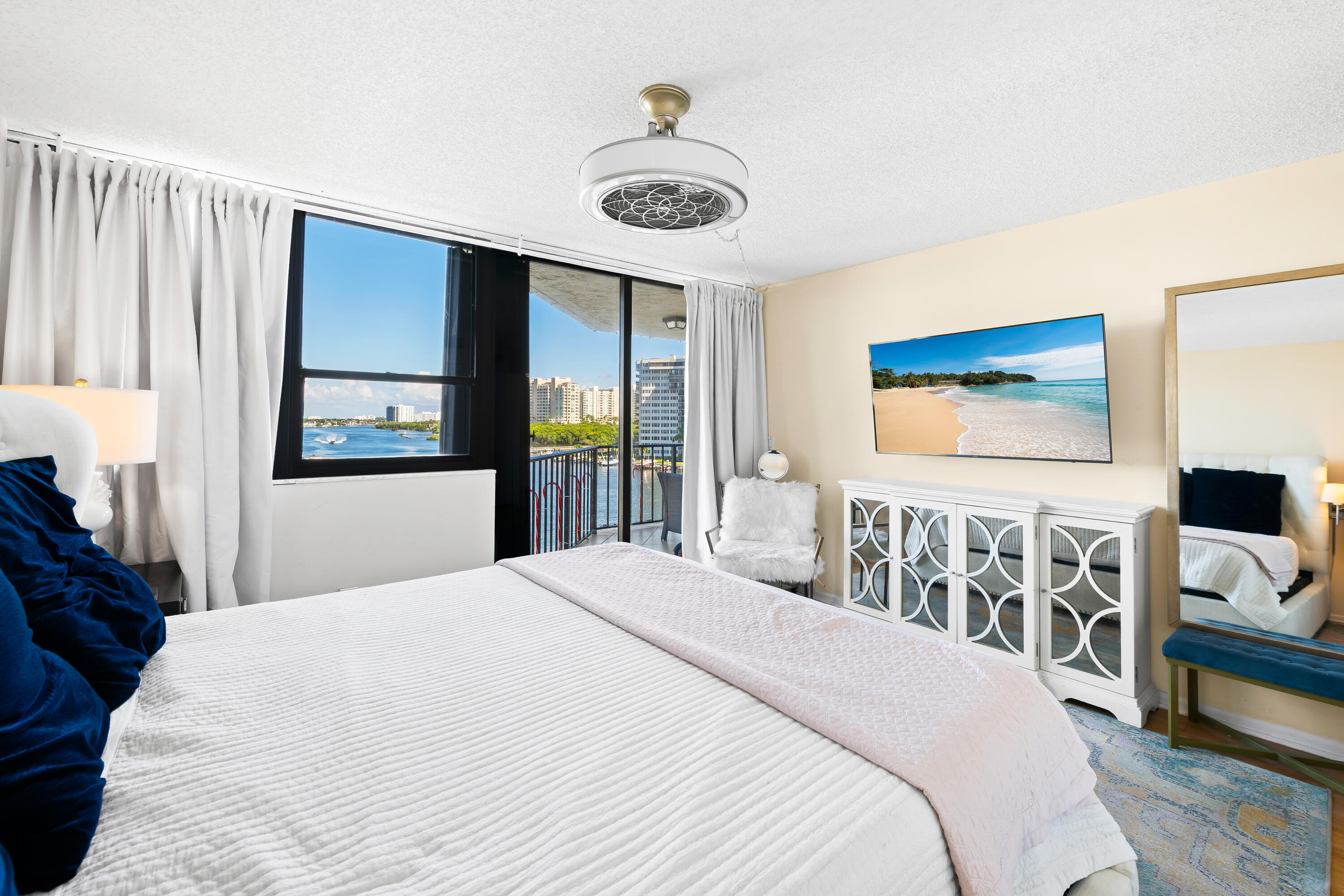 899 Jeffery Street, Unit 614 Boca Raton, FL 33487 - Photo 26 of 60 a bedroom with a bed a table and painting on the wall