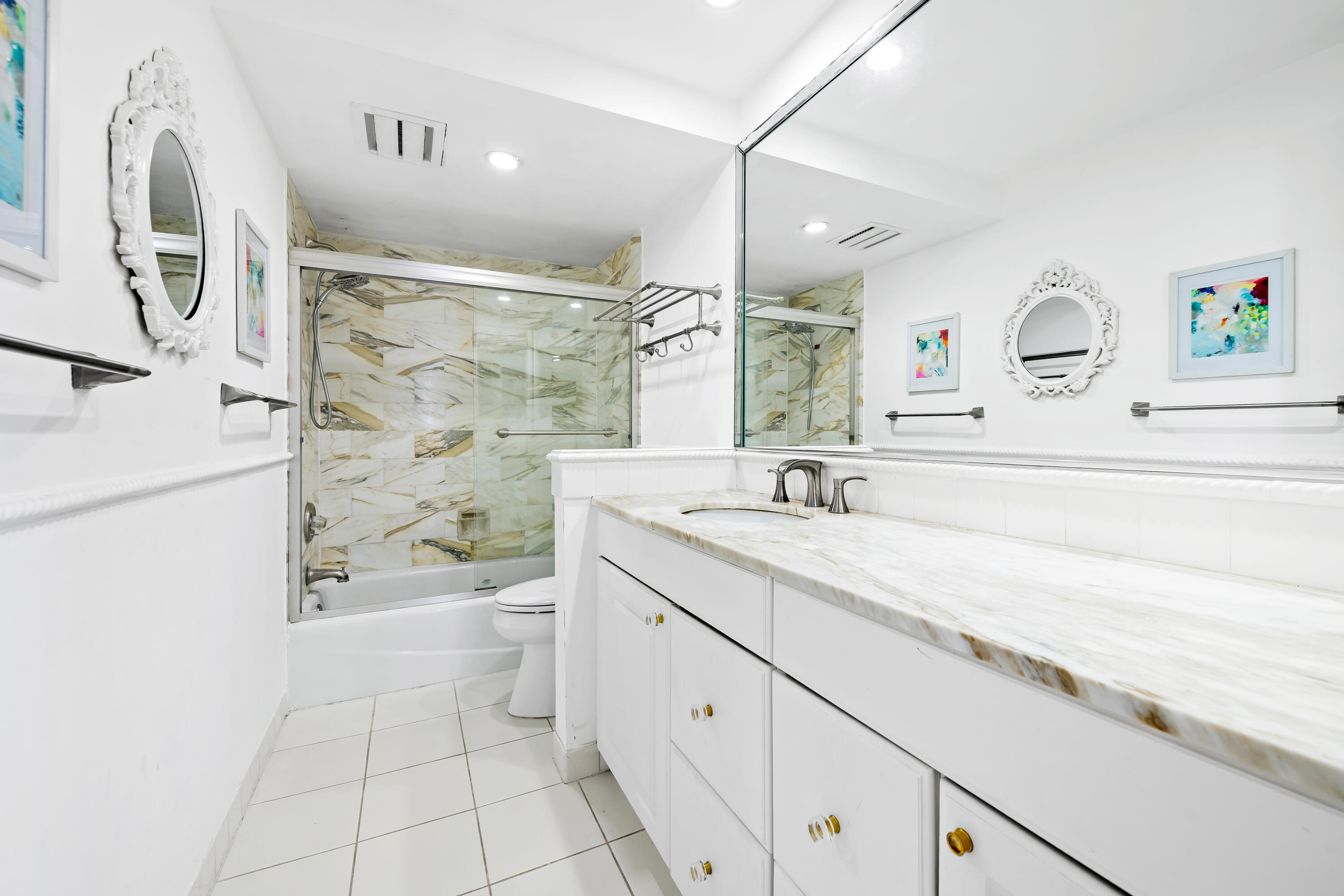 899 Jeffery Street, Unit 614 Boca Raton, FL 33487 - Photo 27 of 60 a spacious bathroom with a granite countertop sink a toilet a mirror and shower