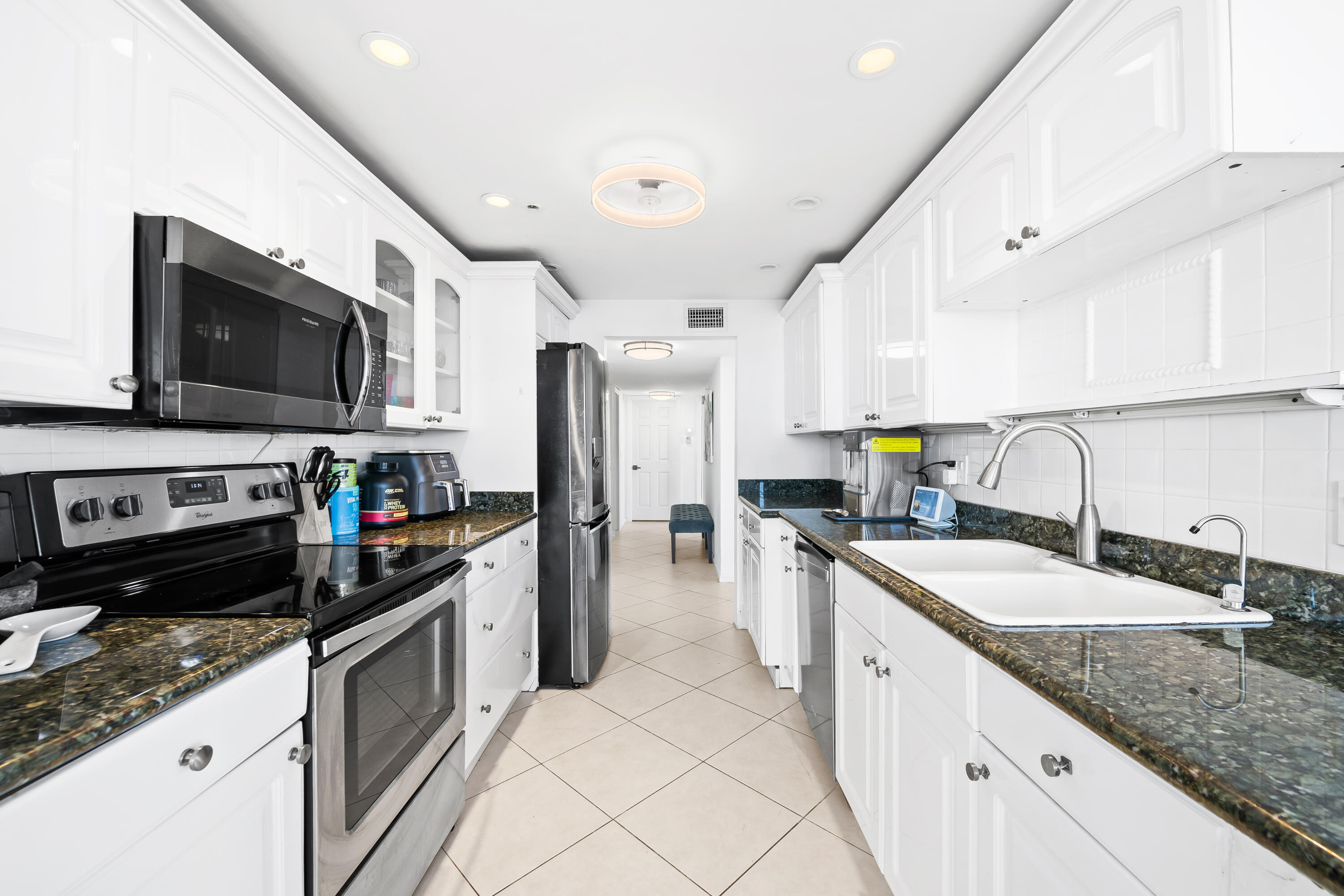 899 Jeffery Street, Unit 614 Boca Raton, FL 33487 - Photo 8 of 60 a kitchen with a sink microwave and refrigerator