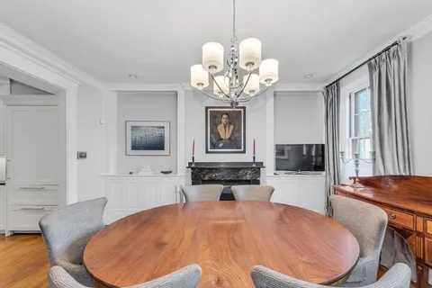 a large white kitchen with a table and chairs