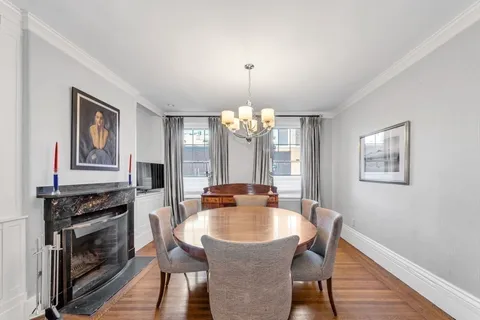 a dining room with furniture and window