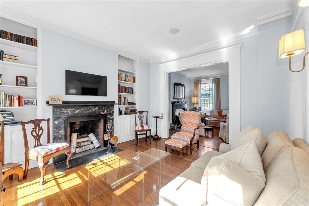 52 River Street Boston, MA 02108 - Photo 18 of 37 a living room with furniture a fireplace and a flat screen tv
