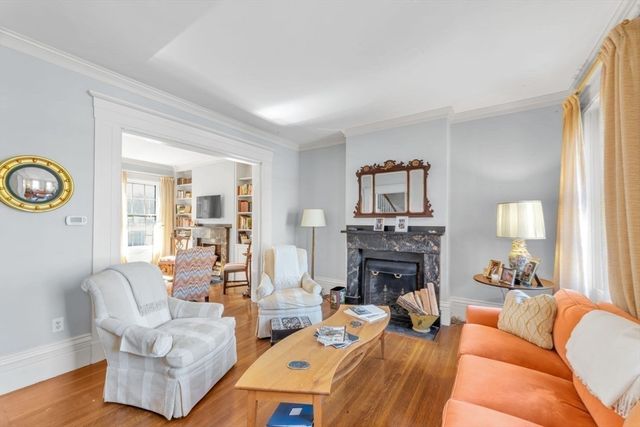 a living room with furniture fireplace and a window