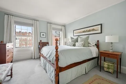 a bed room with a bed and a window