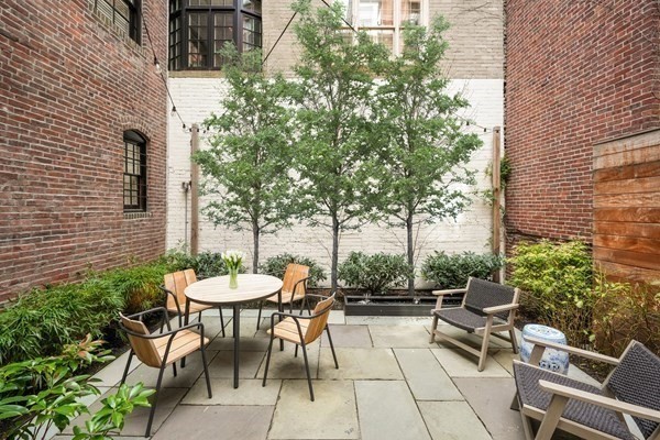 52 River Street Boston, MA 02108 - Photo 3 of 37 a view of a patio with a table and chairs and a barbeque