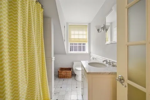 a bathroom with a sink a mirror and a shower curtain