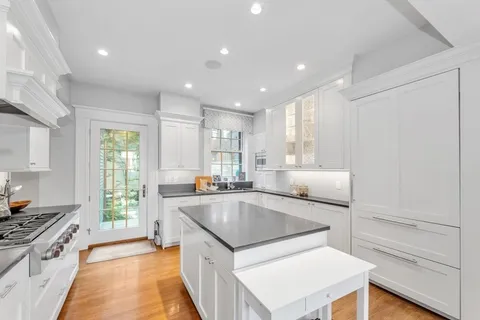 a kitchen with a stove sink and cabinets
