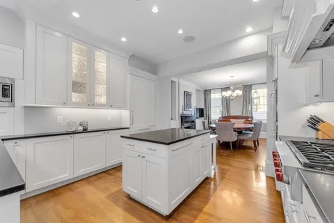 a living room with stainless steel appliances granite countertop furniture and a kitchen view