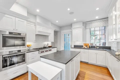 a kitchen with stainless steel appliances a stove sink microwave and cabinets