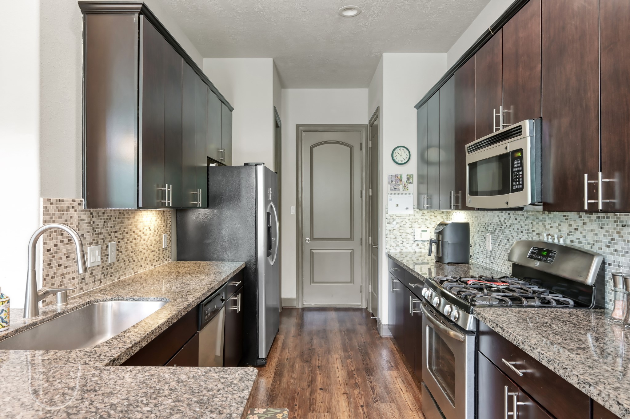 18 Aventura Place Spring, TX 77389 - Photo 16 of 43 a kitchen with stainless steel appliances granite countertop a sink stove and refrigerator