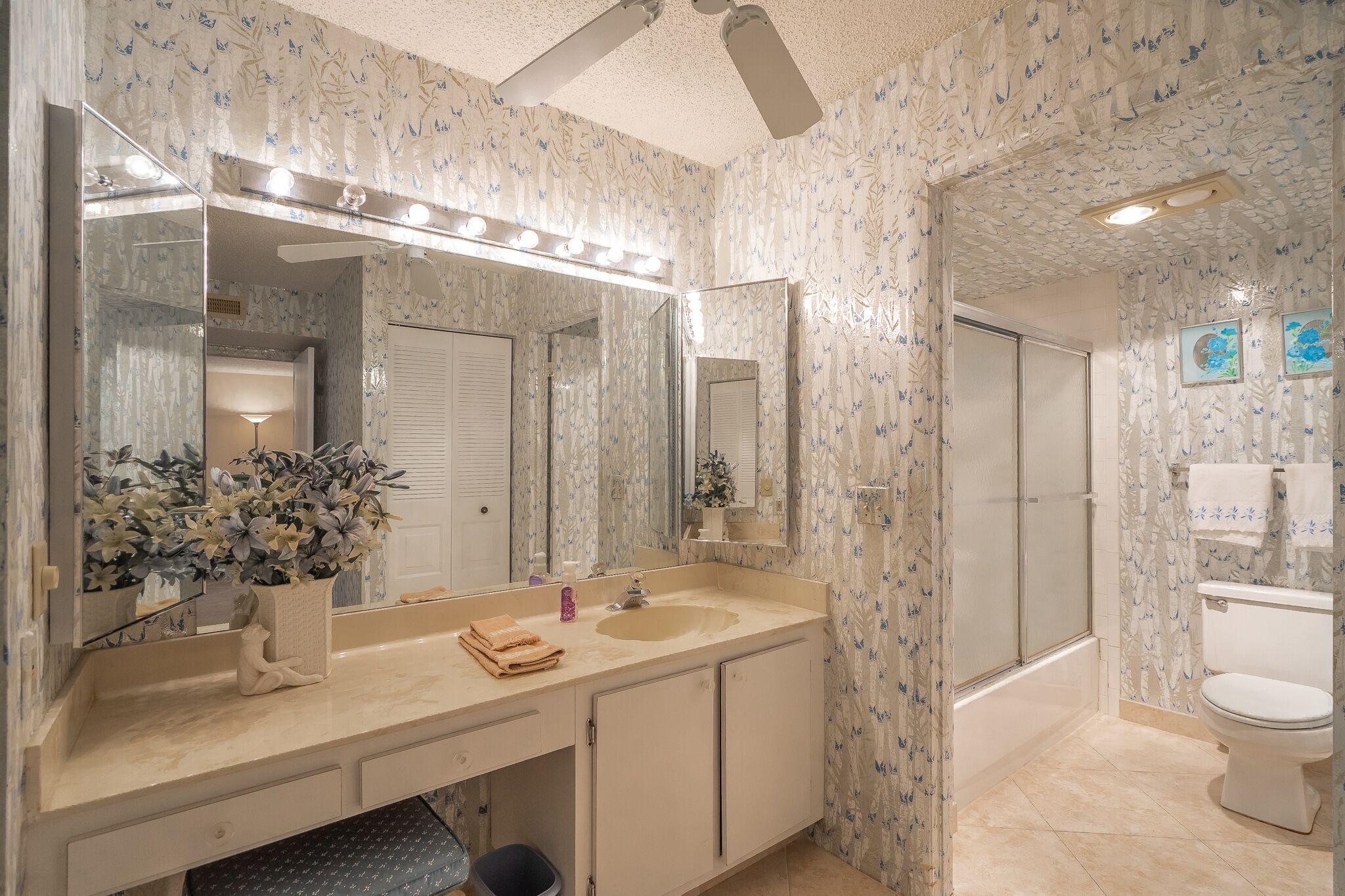 9276 Vista Del Lago, Unit E Boca Raton, FL 33428 - Photo 12 of 23 a bathroom with a sink and a mirror