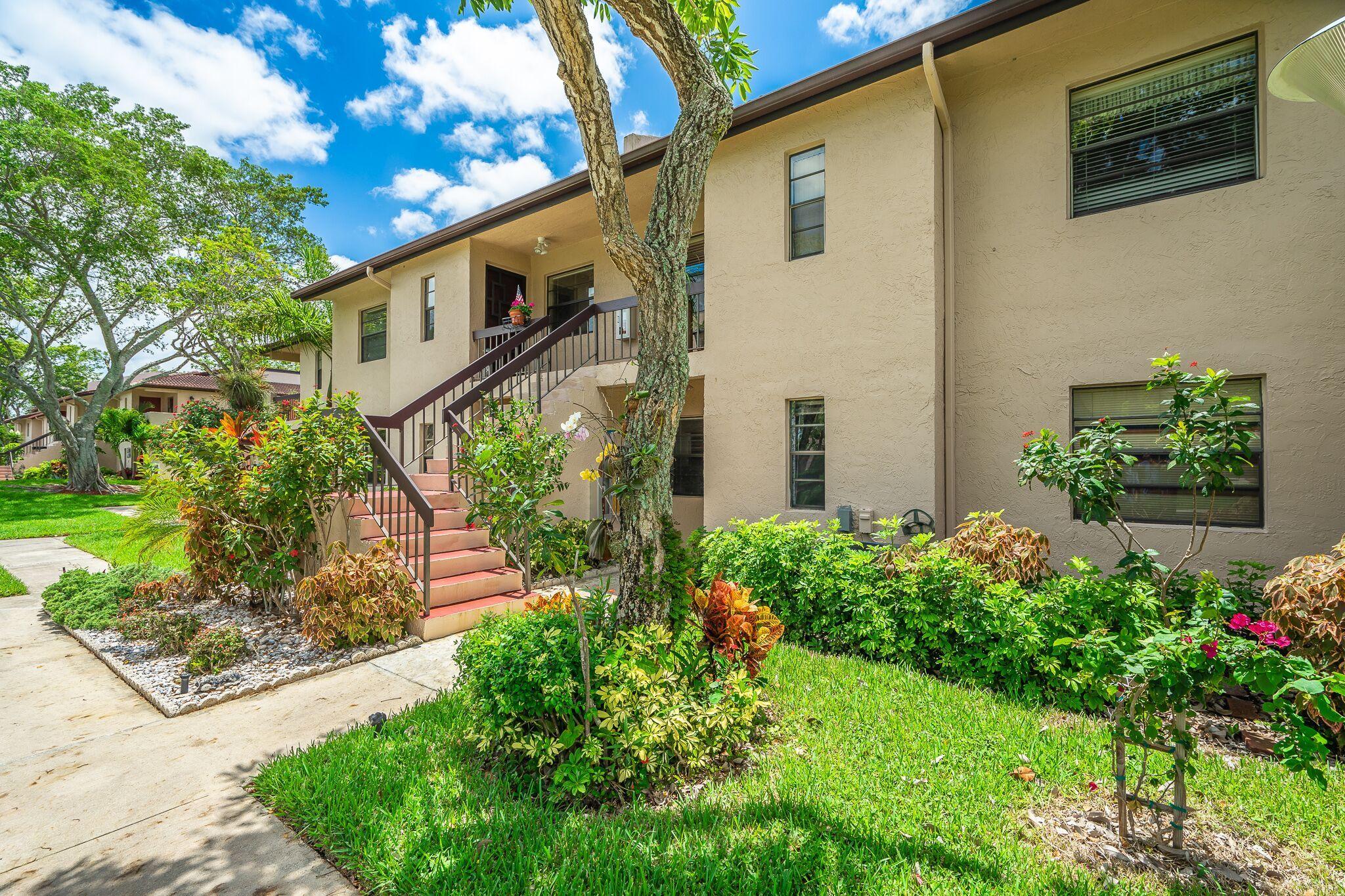 9276 Vista Del Lago, Unit E Boca Raton, FL 33428 - Photo 19 of 23 a front view of a house with garden